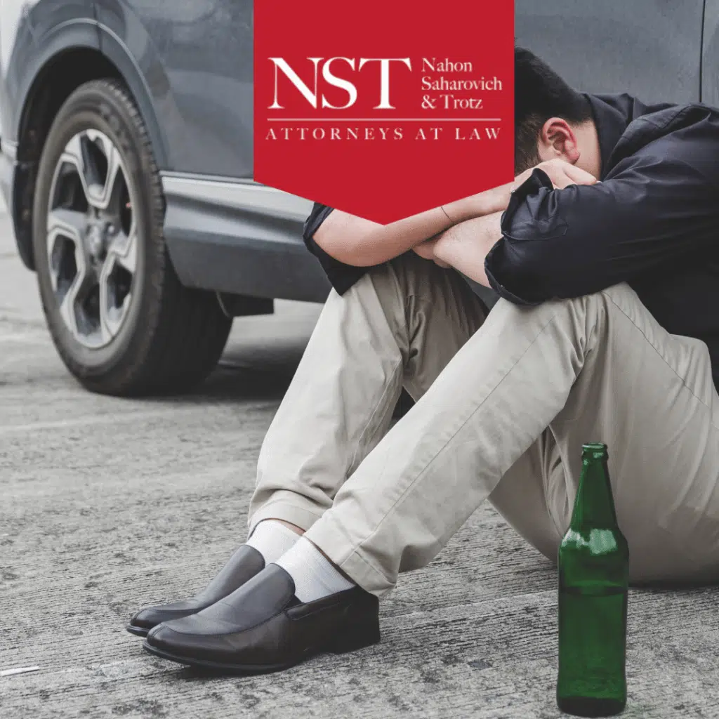 drunk driver sitting by car after accident