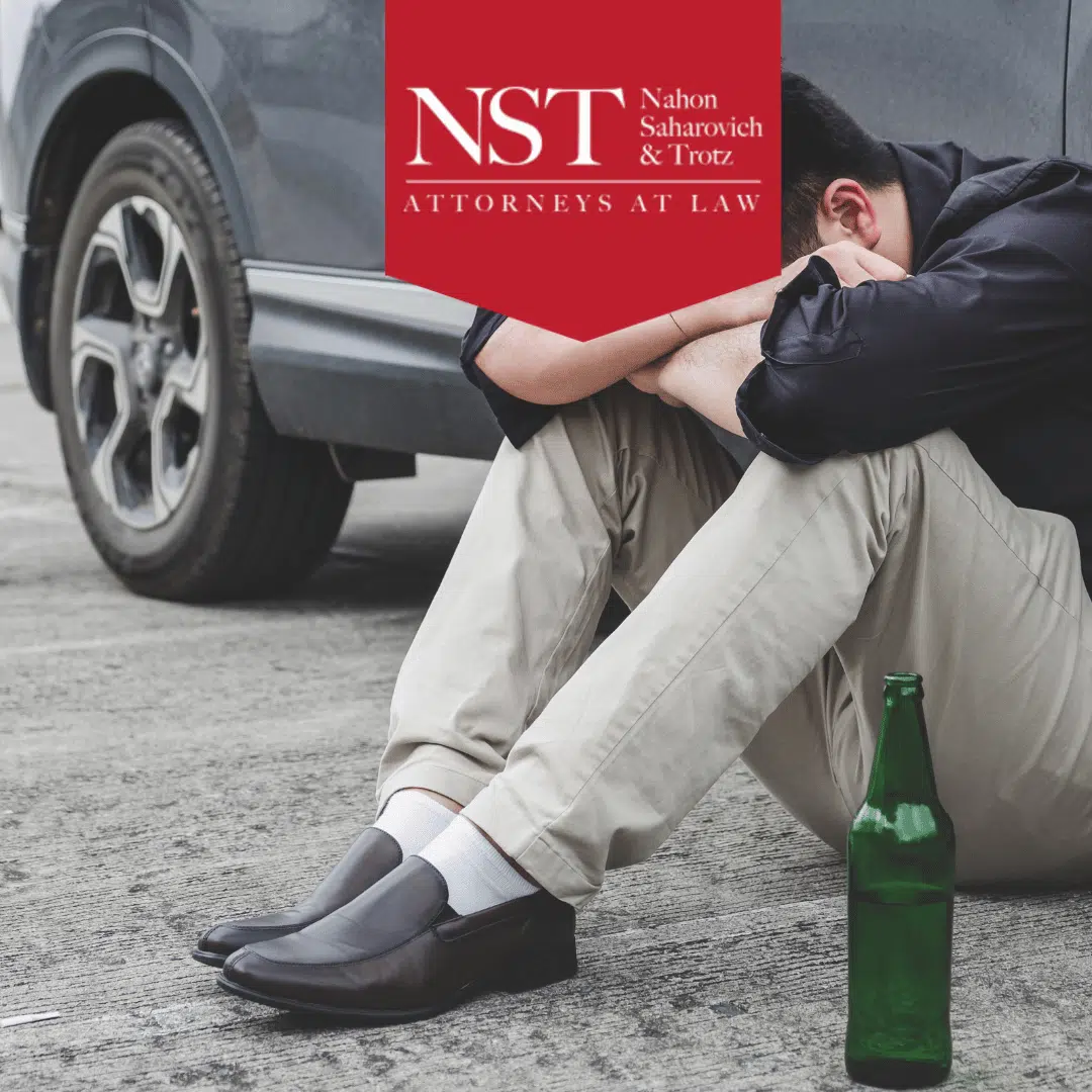 drunk driver sitting by car after accident
