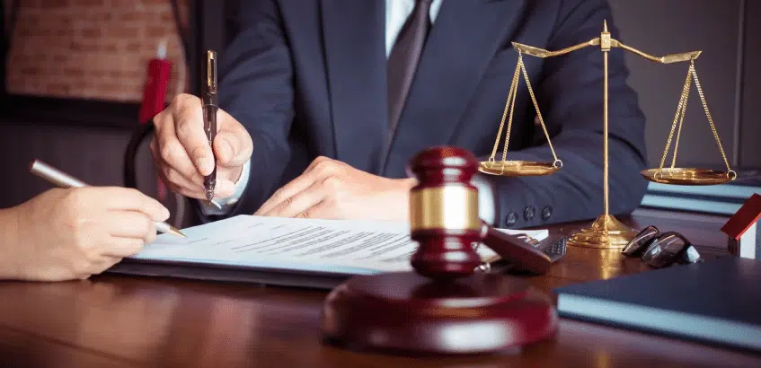 A lawyer and client signing an important document