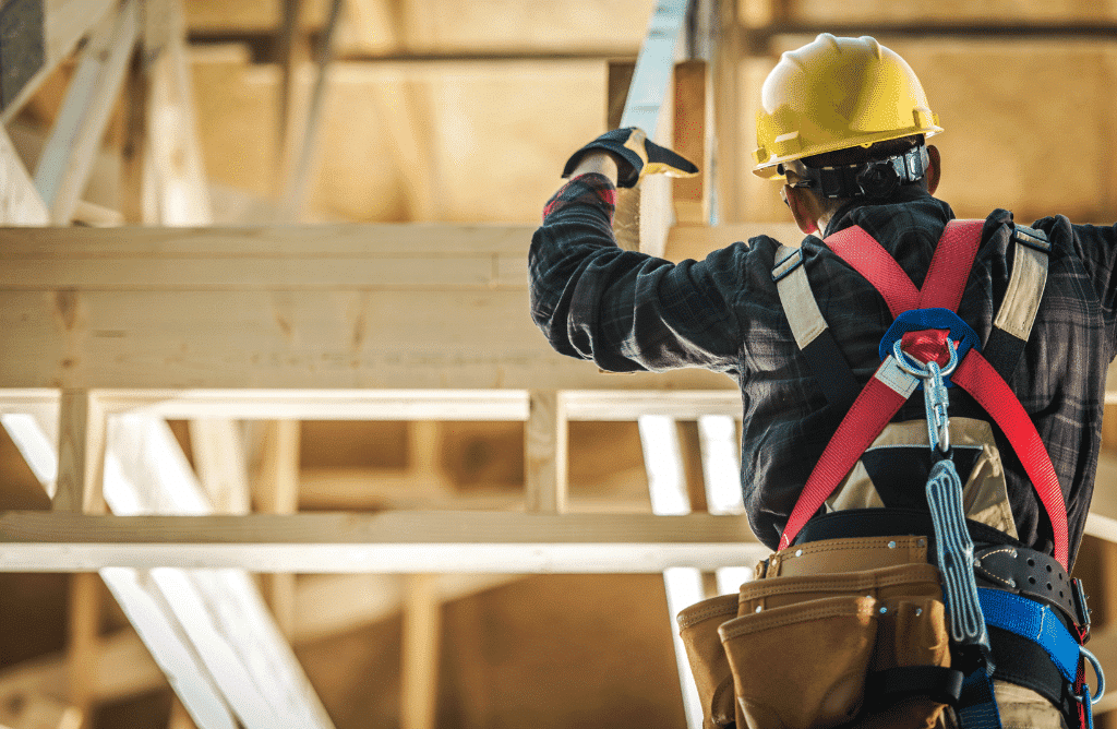 A construction worker doing work on a house