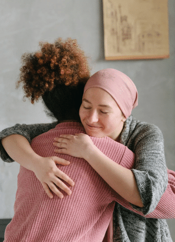 A cancer patient hugging their friend