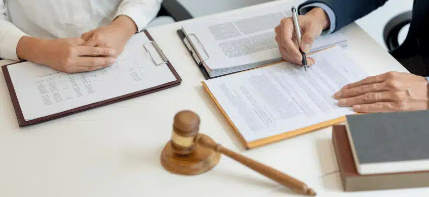 A lawyer and a client signing documents