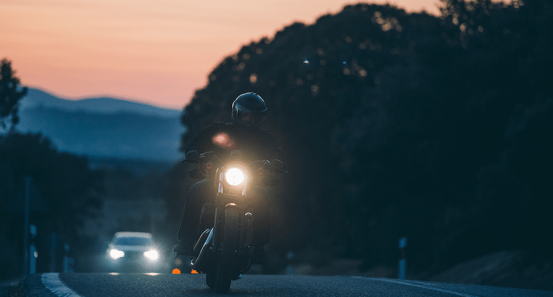 Man Riding Motorcycle at Dusk