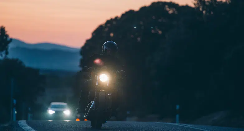 Man Riding Motorcycle at Dusk