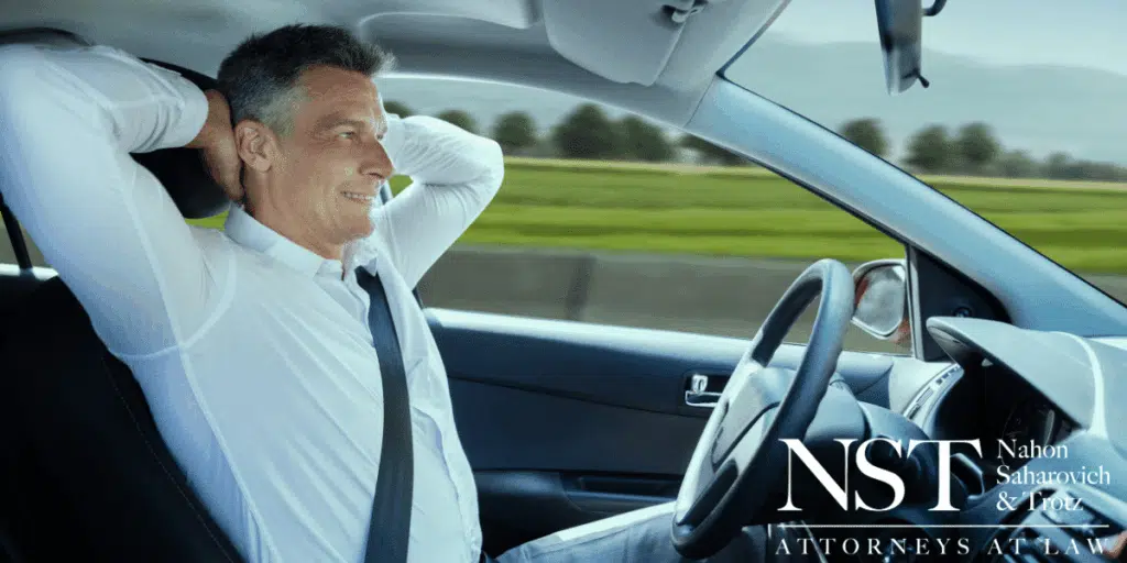 man behind the wheel of a self-driving car