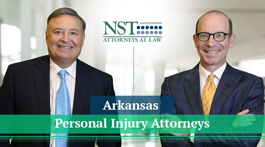 NST Law team photo with banner text "Arkansas Personal Injury Attorneys"
