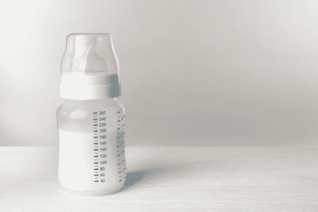 Feeding Bottle of Baby Milk Formula on Table