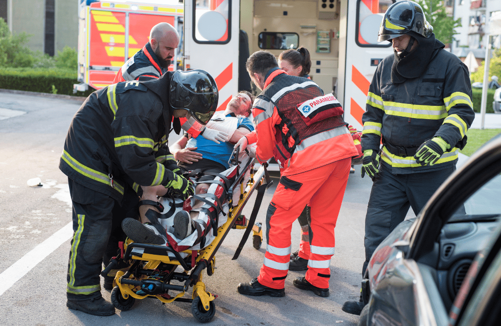 Photo of paramedics helping a car accident victim with injuries