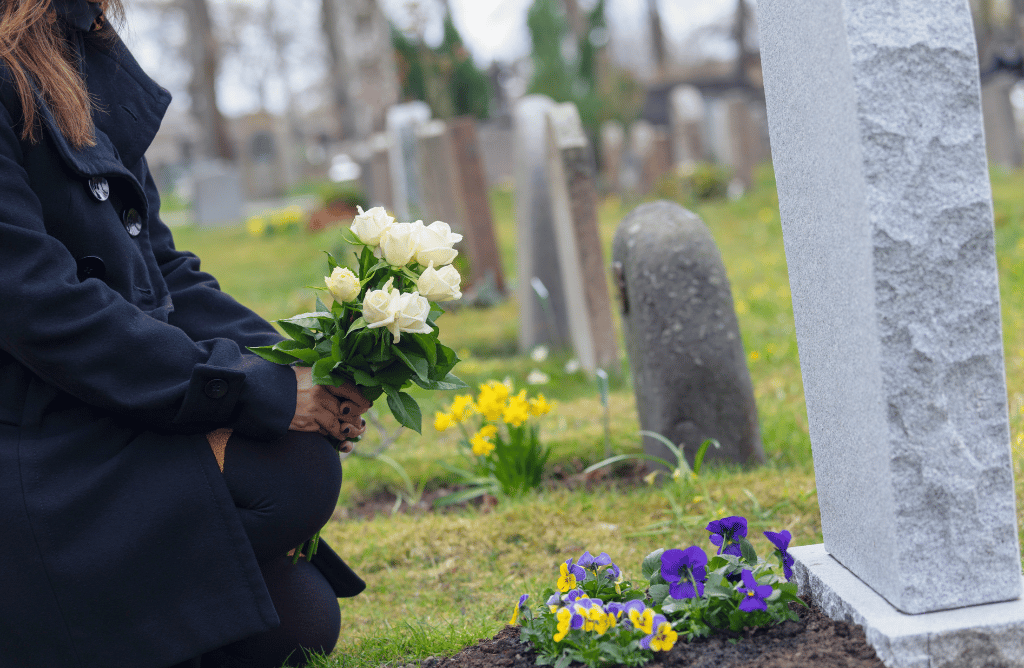 Photo of a woman in at loved ones grave after wrongful death