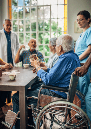 elderly people playing cards in a nursing home