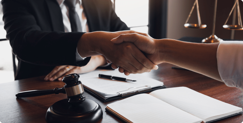A lawyer shaking hands with their client