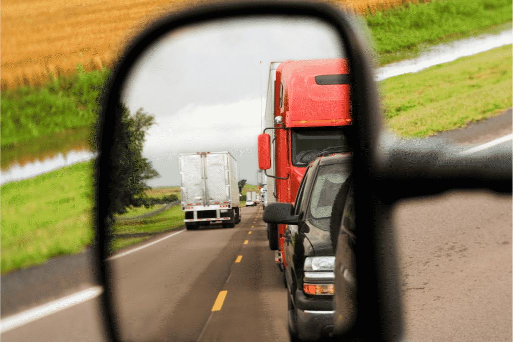 Reflection of semi-trucks in side view mirror