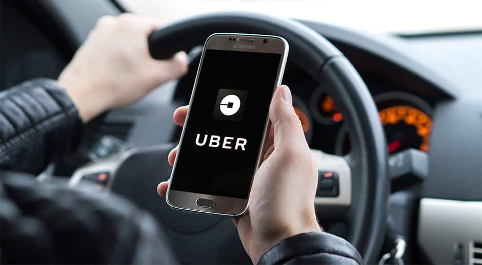 Driver holding phone with uber app open