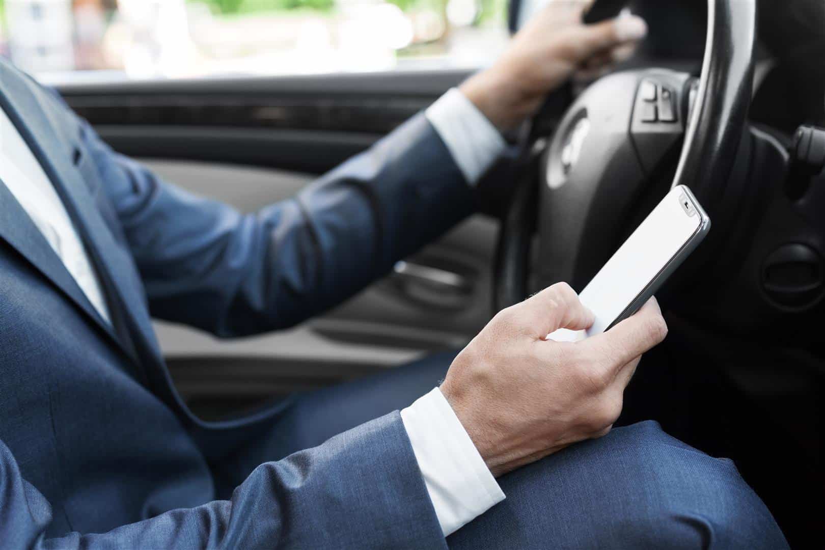 Business man texting and driving