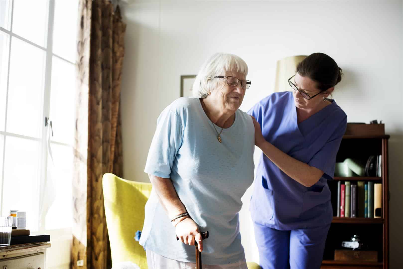 Nurse helping elderly woman